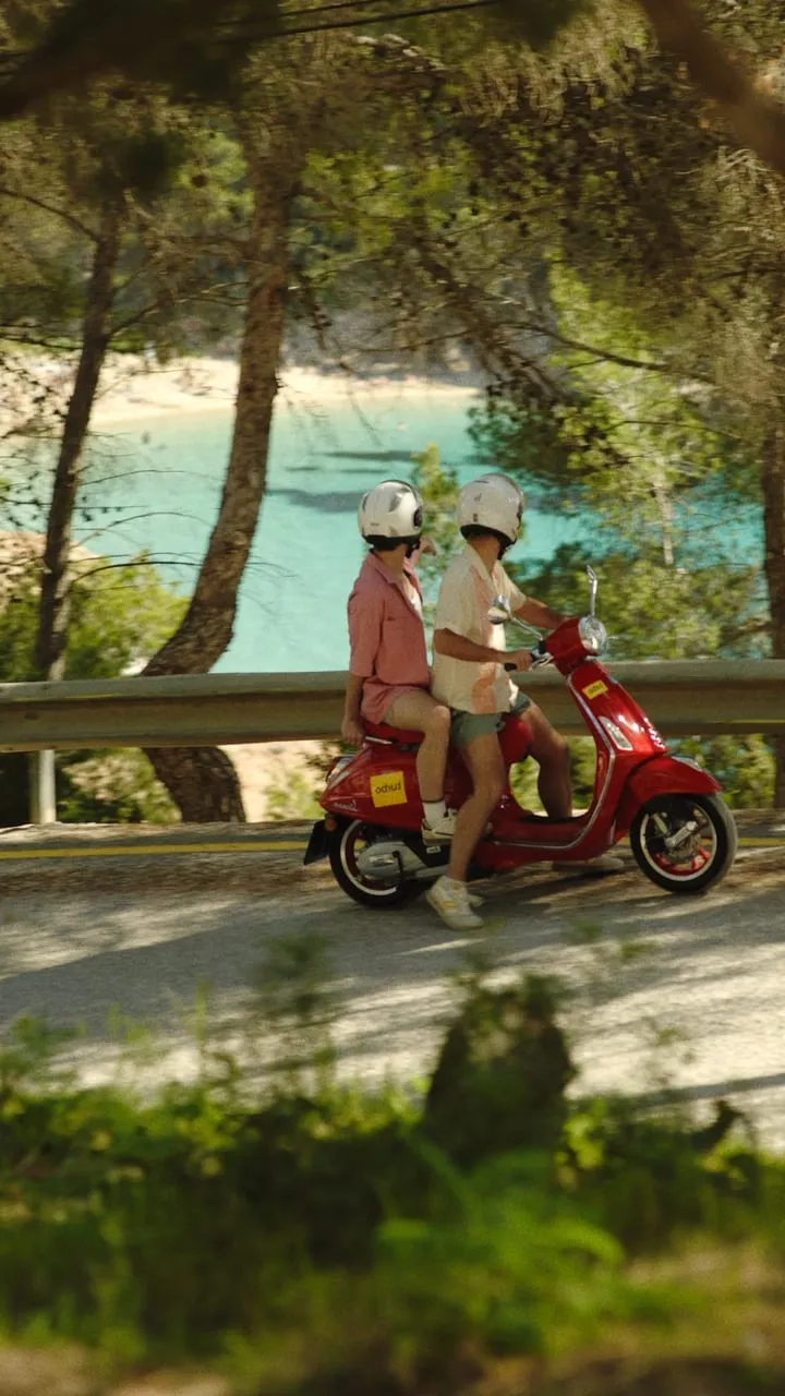 Talent on a motorbike at a tropical location during a shoot.