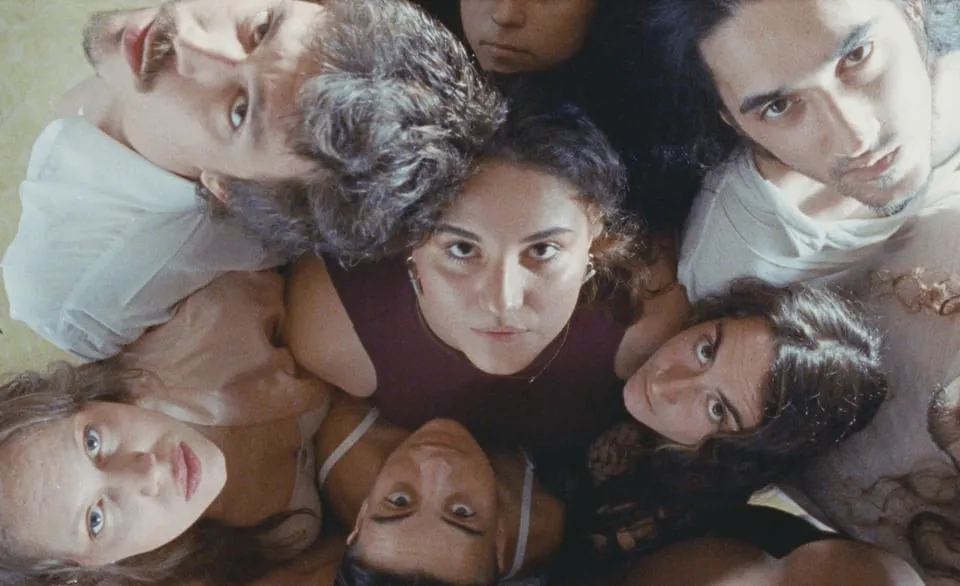 Group of creators gathered, seen from above, during a production session.